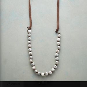 SUNDANCE round pearls with adjustable tan leather strips with fringe on the end!